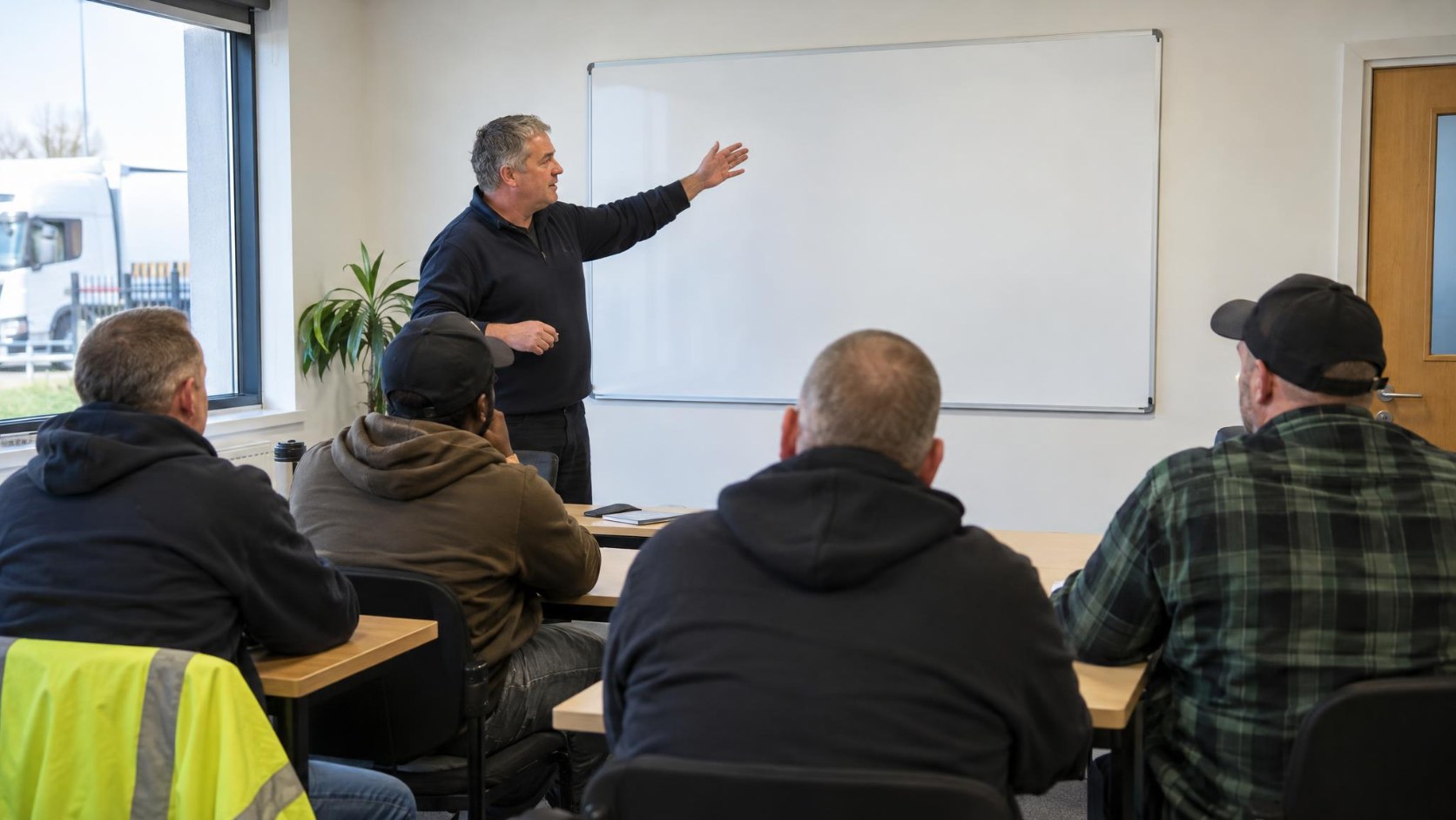 Professional HGV drivers taking part in Driver CPC periodic training in a classroom